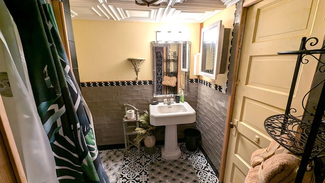 bathroom featuring tile walls, backsplash, and tile patterned floors