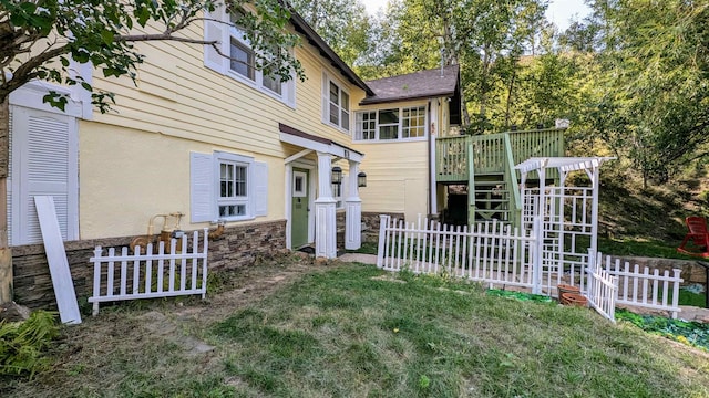 back of house with a yard and a deck