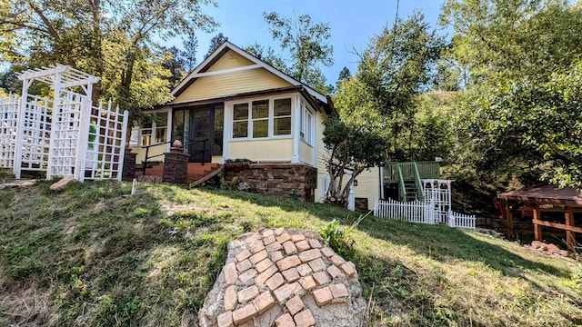 back of property with a sunroom