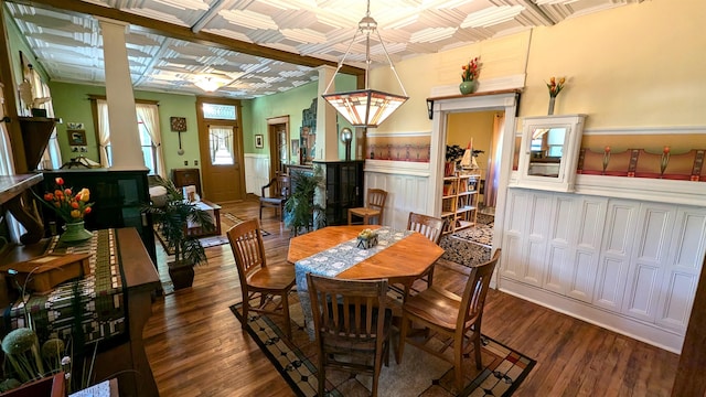 dining space with dark wood-type flooring and coffered ceiling