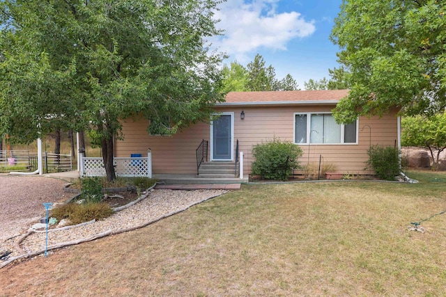 ranch-style house with entry steps and a front lawn