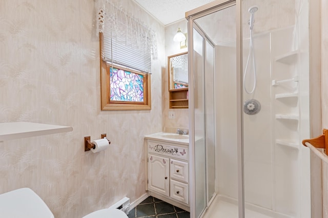 bathroom featuring vanity, a shower stall, and toilet