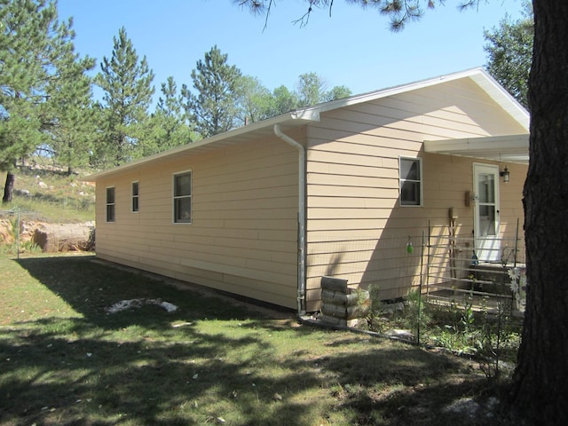 view of property exterior with a yard