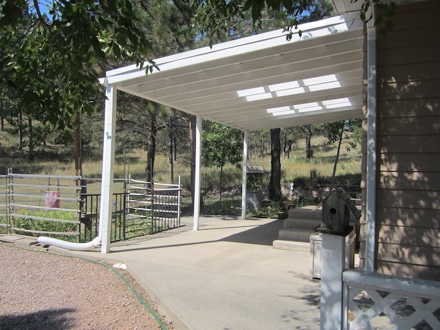 exterior space featuring a carport and fence