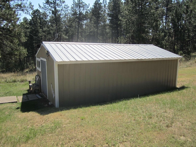 view of side of property with a yard and an outdoor structure