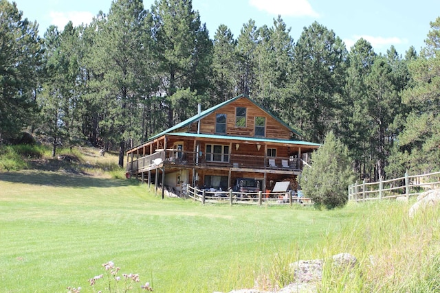 back of house featuring a yard and a wooden deck