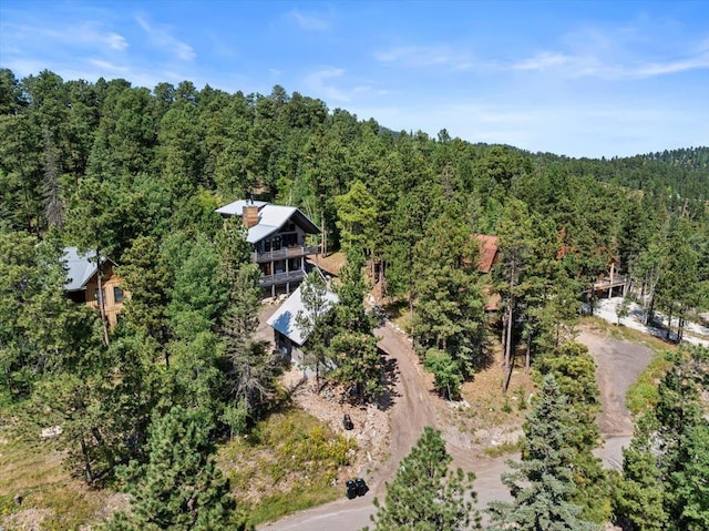 drone / aerial view featuring a wooded view