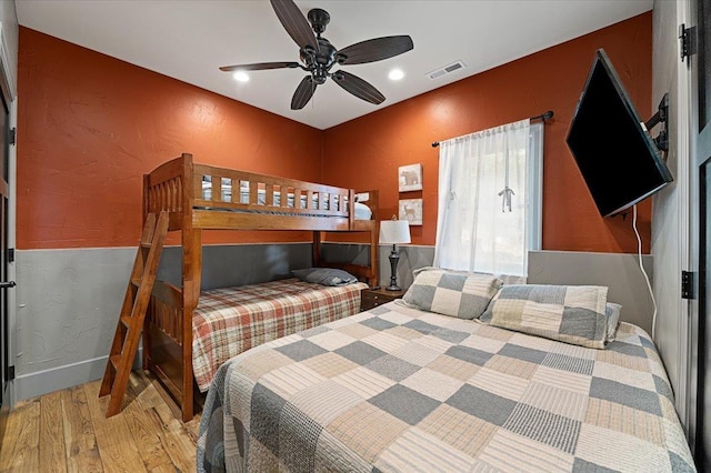 bedroom featuring recessed lighting, visible vents, a textured wall, a ceiling fan, and wood finished floors