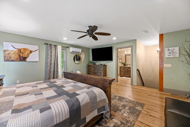 bedroom featuring a ceiling fan, recessed lighting, an AC wall unit, and wood finished floors