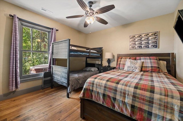 bedroom featuring ceiling fan, hardwood / wood-style flooring, and visible vents