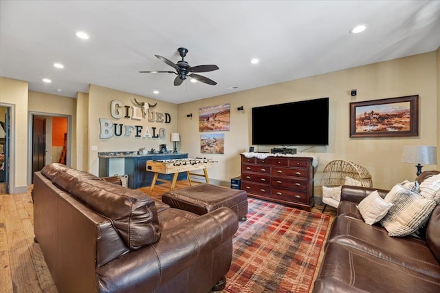 living room with ceiling fan and wood-type flooring