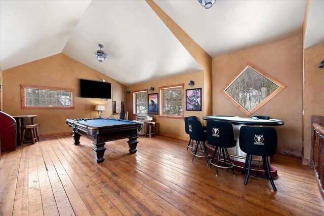 playroom featuring billiards, plenty of natural light, vaulted ceiling, and hardwood / wood-style flooring