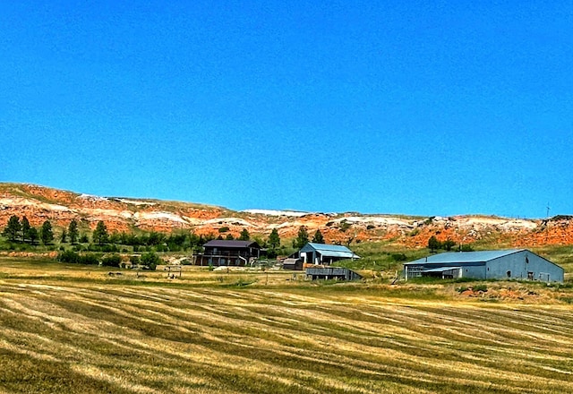 exterior space with a rural view and a mountain view