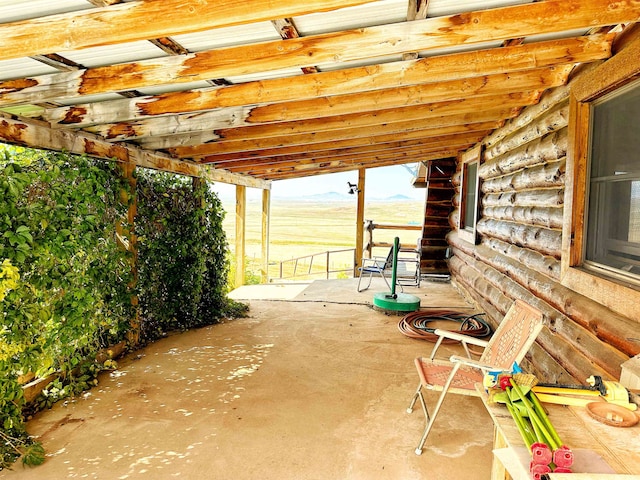 view of patio with a rural view and a pergola