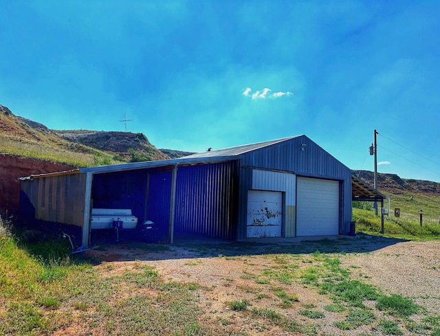 view of outbuilding with a mountain view and a garage