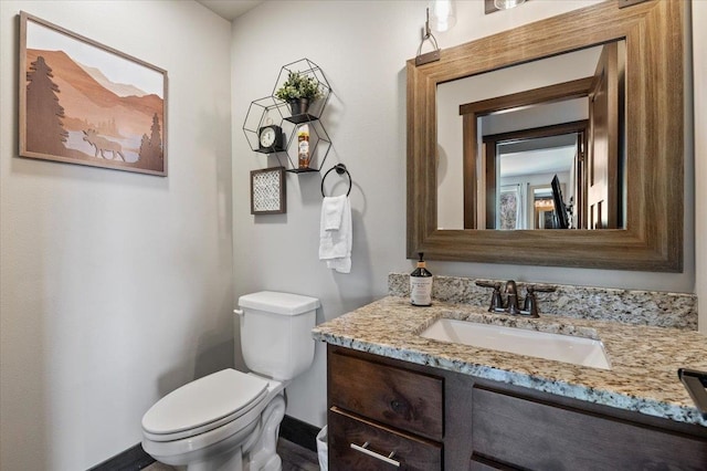 bathroom with toilet and vanity