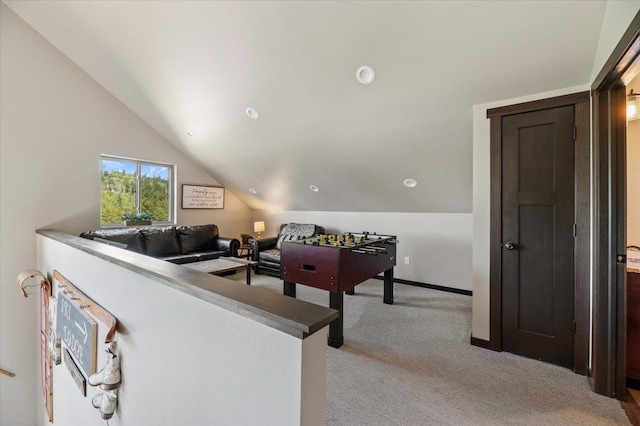 playroom featuring lofted ceiling and light colored carpet