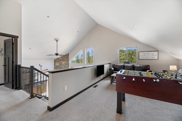 recreation room featuring lofted ceiling, ceiling fan, and light carpet