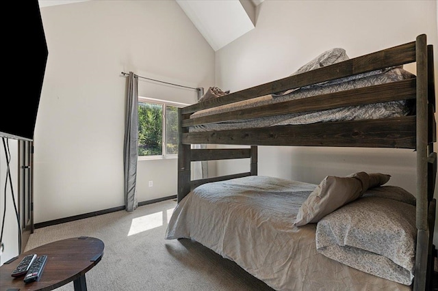 carpeted bedroom featuring lofted ceiling