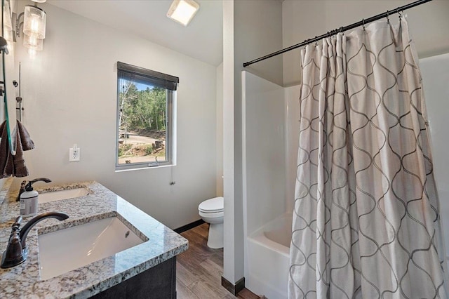 full bathroom with vanity, toilet, hardwood / wood-style flooring, and shower / bath combo