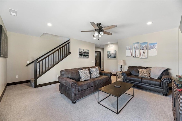 carpeted living room with ceiling fan