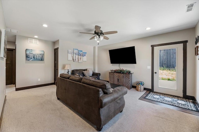 living room with light colored carpet and ceiling fan