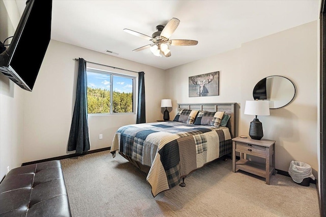 21185 Lost Camp Trl, Lead, SD 57754 - bedroom featuring baseboards, ceiling fan, visible vents, and light carpet