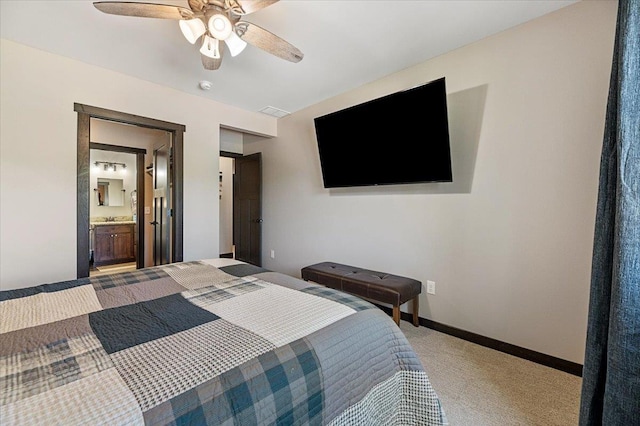 21185 Lost Camp Trl, Lead, SD 57754 - bedroom with a ceiling fan, ensuite bathroom, baseboards, light colored carpet, and visible vents