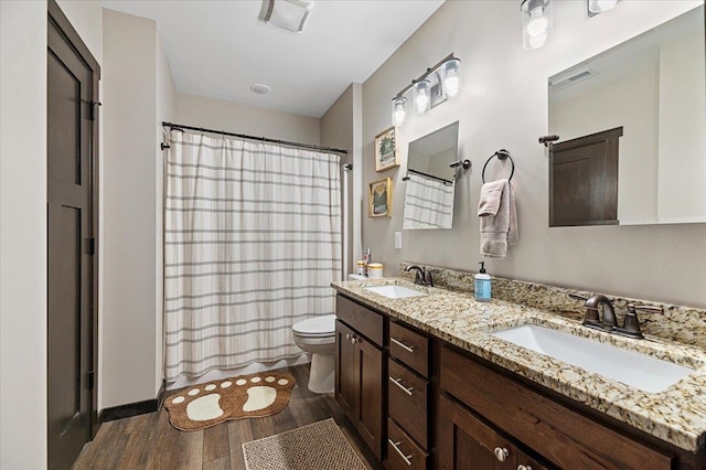 bathroom with vanity, toilet, a shower with shower curtain, and hardwood / wood-style floors