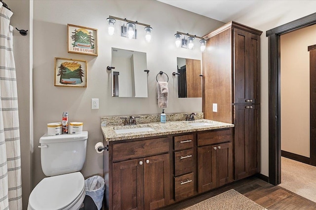 21185 Lost Camp Trl, Lead, SD 57754 - full bath with toilet, a sink, double vanity, and wood finished floors