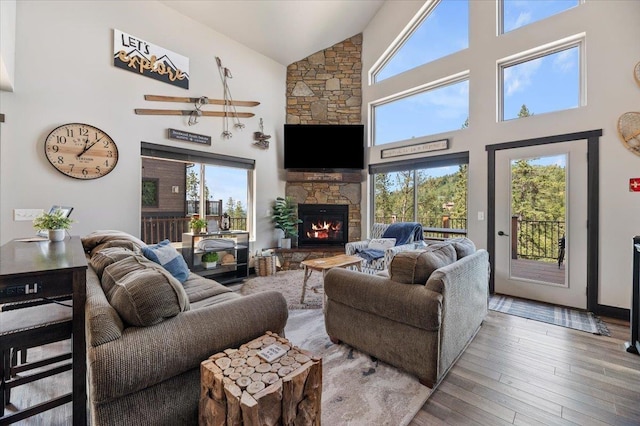 21185 Lost Camp Trl, Lead, SD 57754 - living room with high vaulted ceiling, a fireplace, and wood finished floors