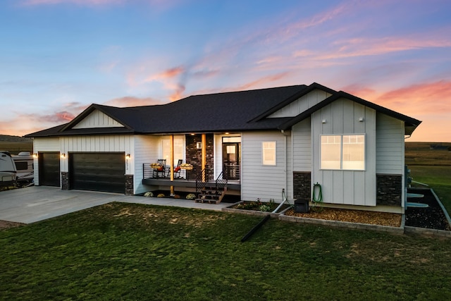 view of front of home featuring a garage and a lawn