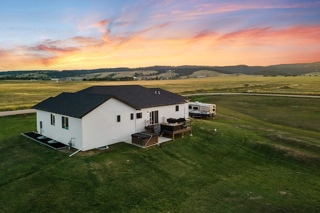 aerial view at dusk featuring a rural view