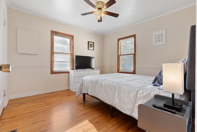 bedroom with crown molding, ceiling fan, and light hardwood / wood-style floors