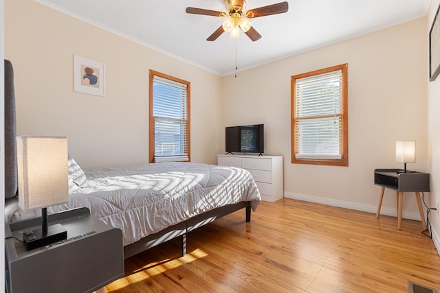 bedroom featuring crown molding, ceiling fan, and light hardwood / wood-style floors