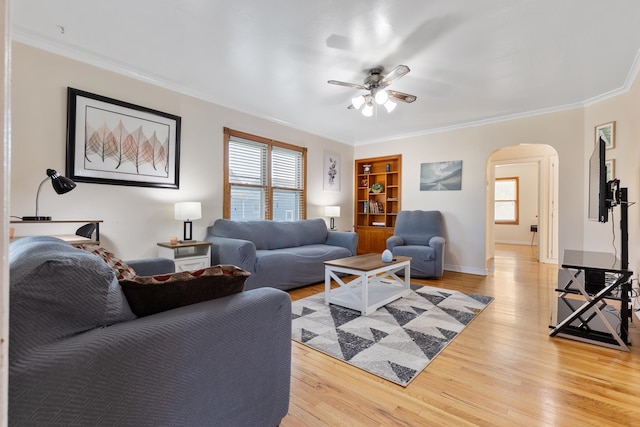 living room with crown molding, light hardwood / wood-style flooring, and ceiling fan