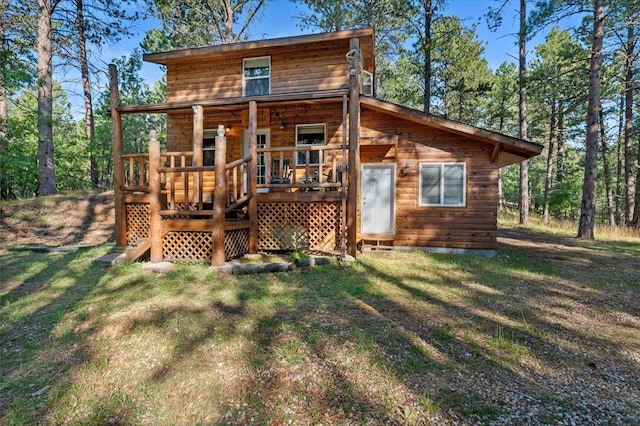 back of property featuring a yard and a deck