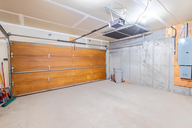 garage with electric panel and a garage door opener