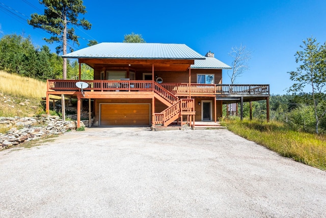 view of front of property with a garage and a deck