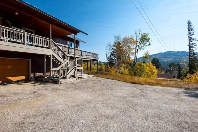view of yard with stairway and driveway