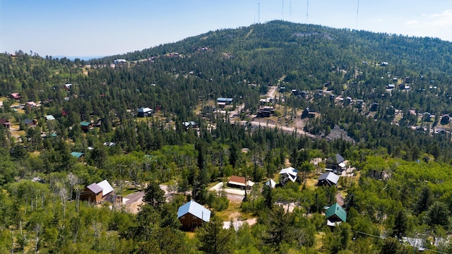 birds eye view of property with a forest view