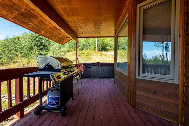 wooden deck featuring a grill