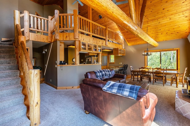 carpeted living room featuring beamed ceiling, a notable chandelier, high vaulted ceiling, and wooden ceiling