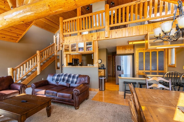 living room with wooden ceiling, light hardwood / wood-style floors, and high vaulted ceiling