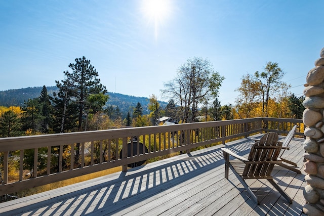 wooden deck with a view of trees