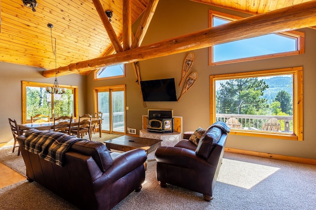 carpeted living room featuring a wood stove, visible vents, a chandelier, wooden ceiling, and beam ceiling