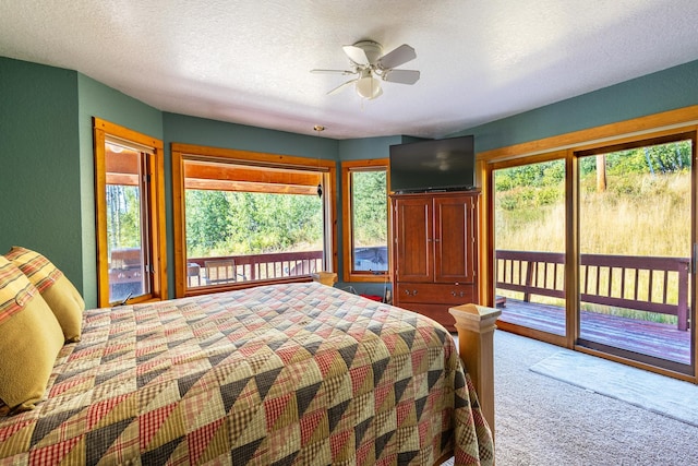 unfurnished bedroom with access to outside, a textured ceiling, carpet, and ceiling fan