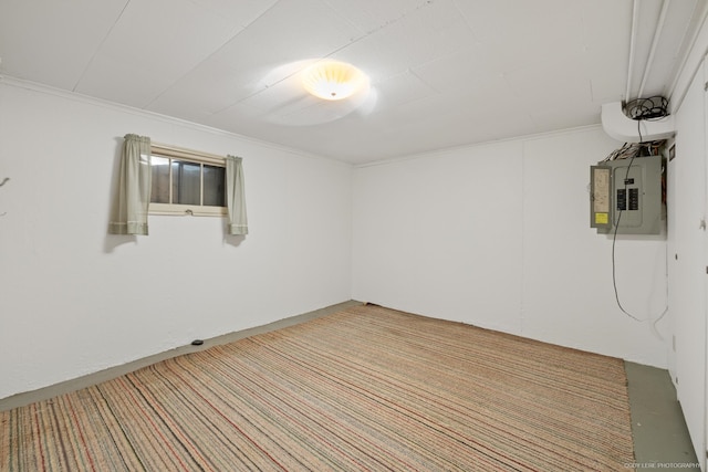 carpeted empty room featuring crown molding and electric panel