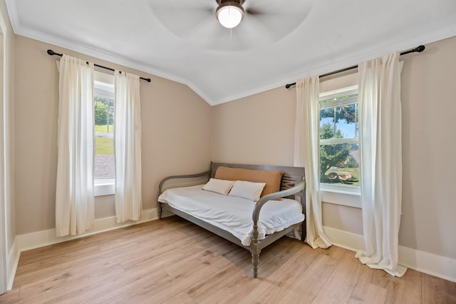 bedroom with light wood-type flooring, ceiling fan, lofted ceiling, and ornamental molding