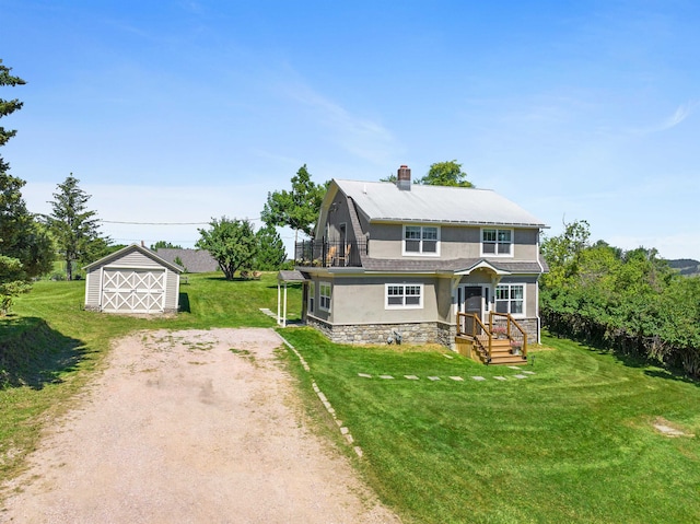 view of front of house featuring a storage unit and a front lawn